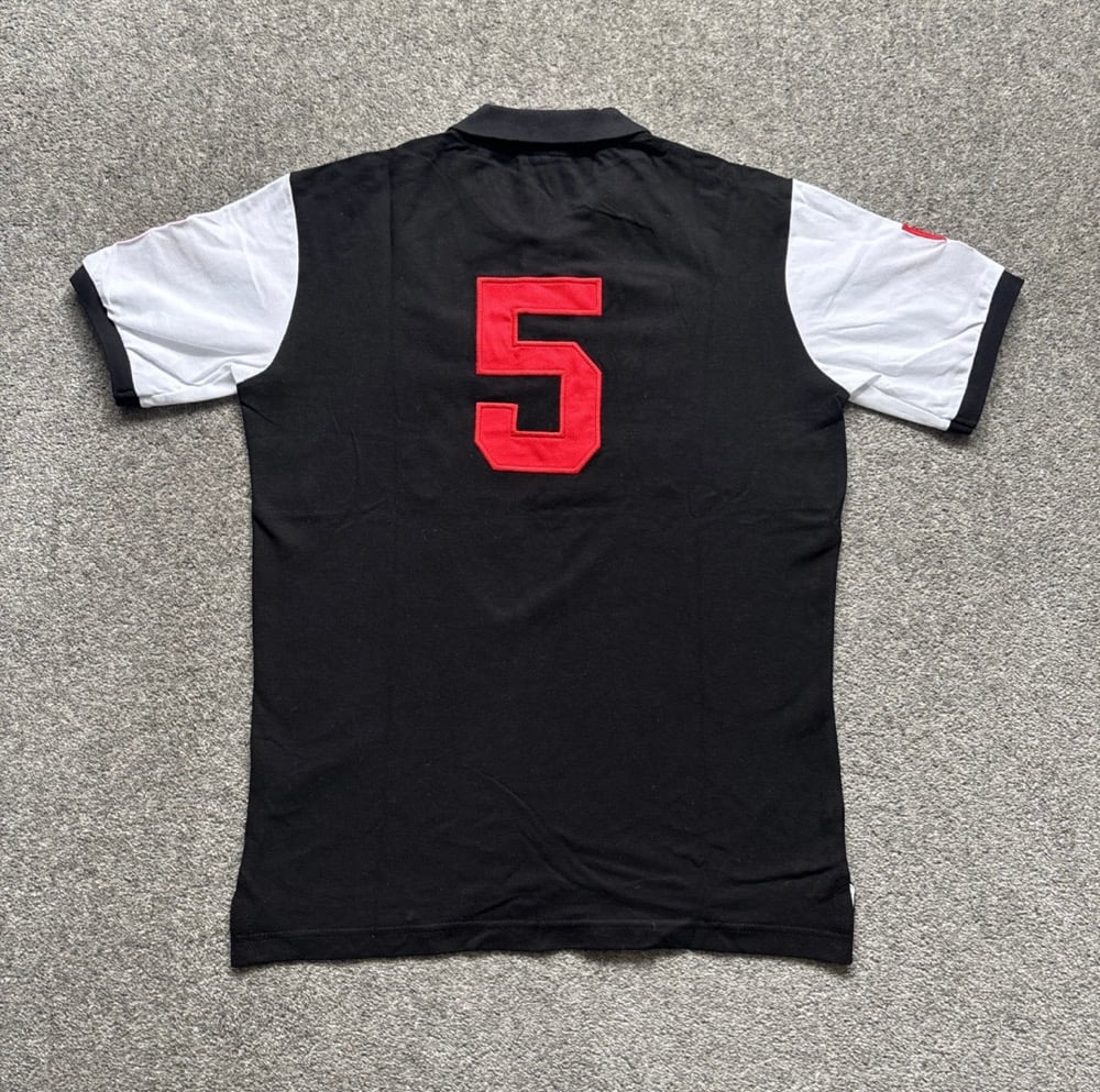 Minimalist side view of Tokyo black polo – contemporary streetwear
